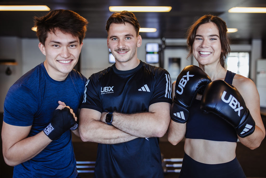 Three people chatting at the gym