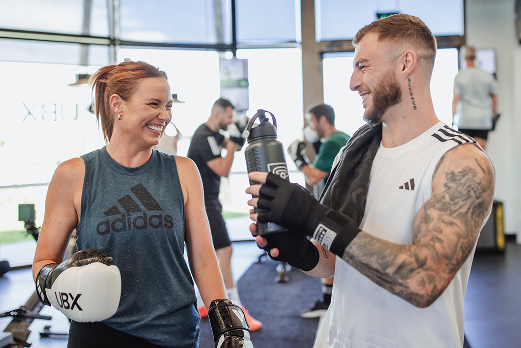 Two people raining hands in air